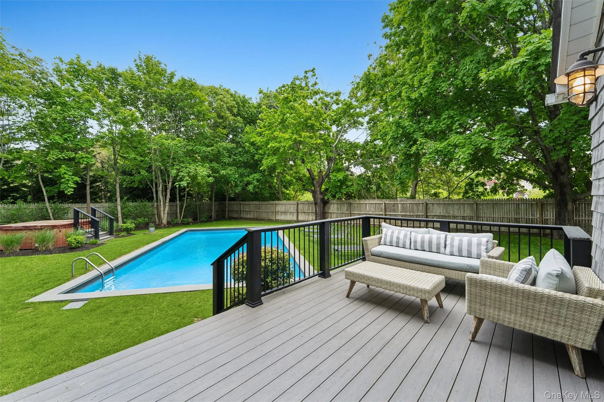 View of pool with a deck, an outdoor hangout area, and view of wooded area View of pool with a deck, an outdoor hangout area, and view of wooded area