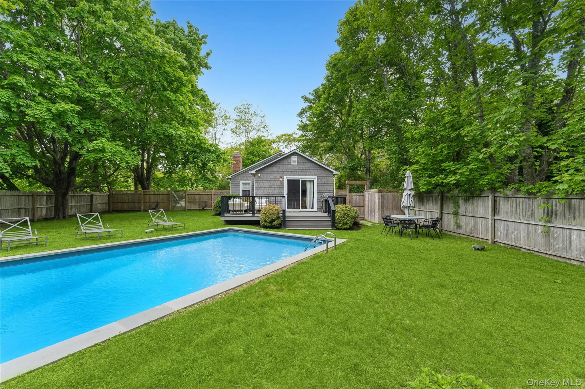 View of pool featuring a wooden deck View of pool featuring a wooden deck
