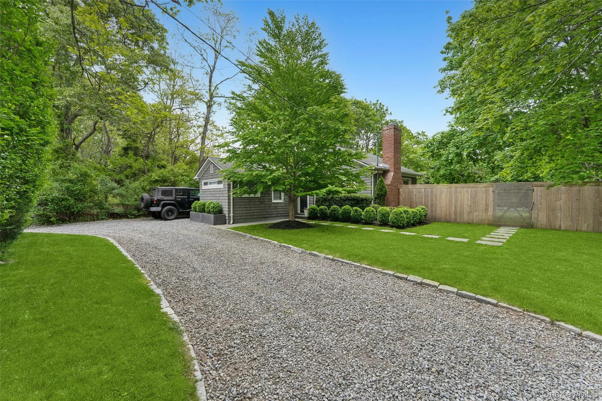 Obstructed view of property featuring gravel driveway Obstructed view of property featuring gravel driveway