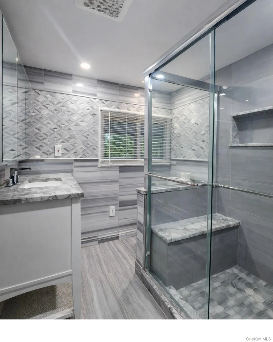 Full bath with vanity, tile walls, and a shower stall Full bath with vanity, tile walls, and a shower stall