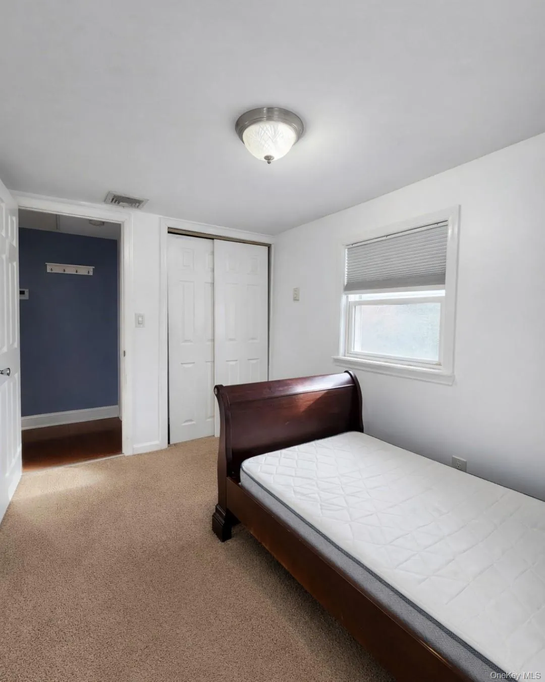 Bedroom with carpet and a closet Bedroom with carpet and a closet