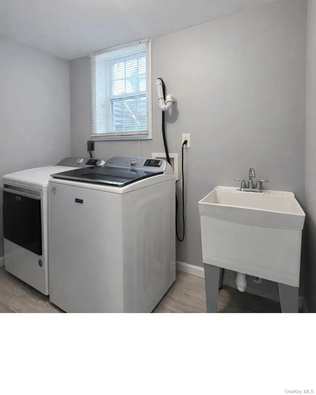 Laundry area featuring washer and dryer and light wood-style floors Laundry area featuring washer and dryer and light wood-style floors