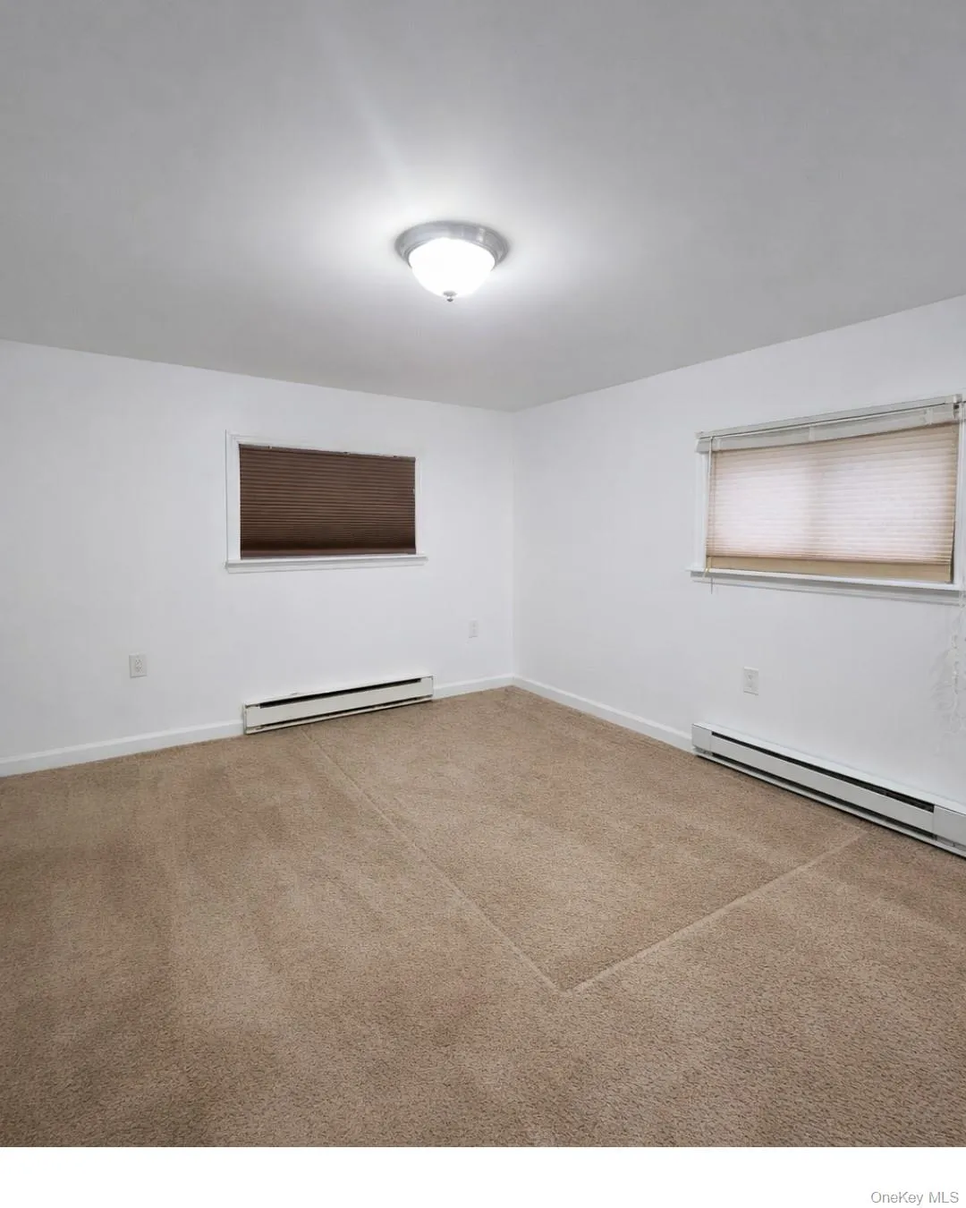 Empty room featuring a baseboard heating unit Empty room featuring a baseboard heating unit