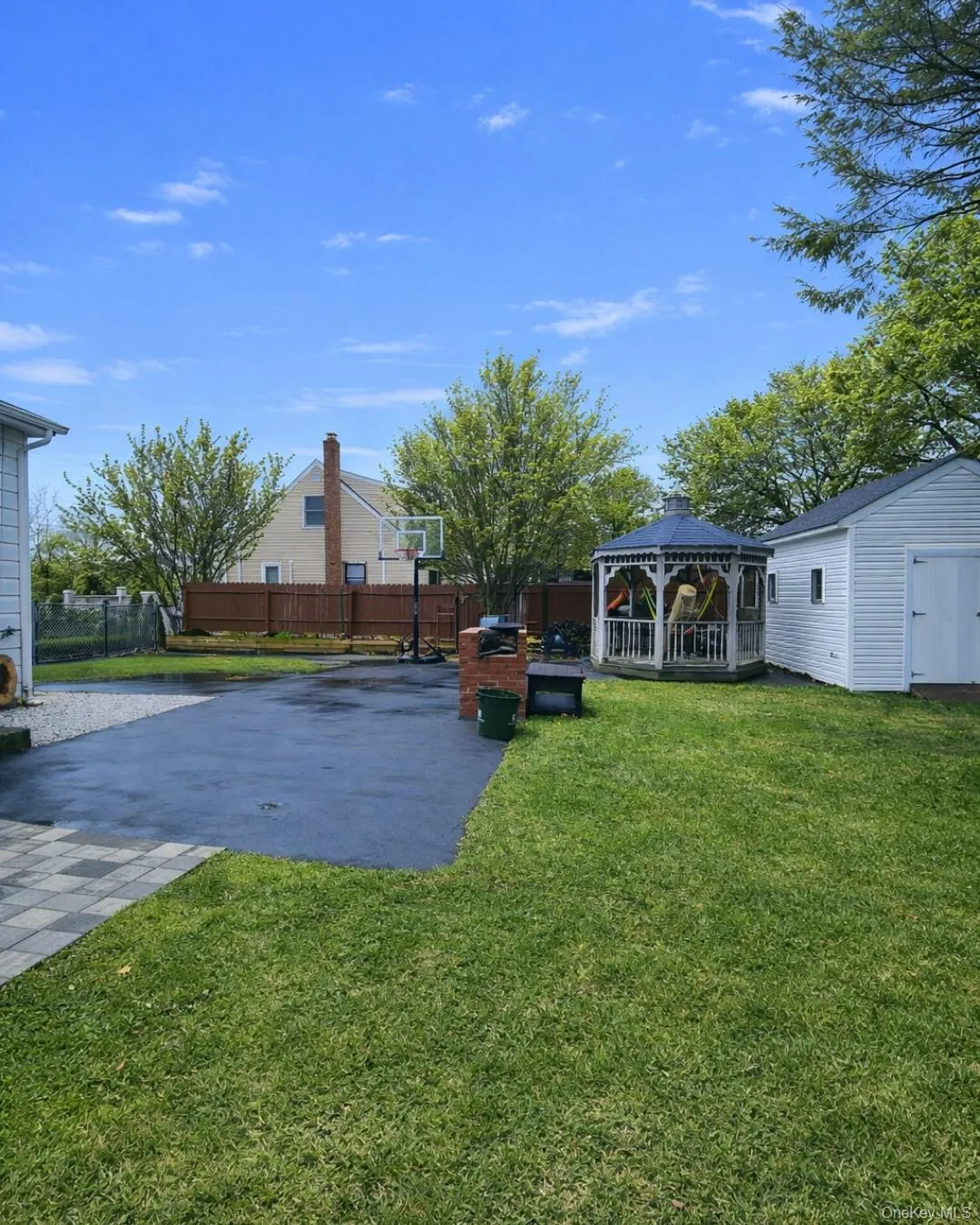 Fenced backyard with a gazebo, a patio, and a storage unit Fenced backyard with a gazebo, a patio, and a storage unit
