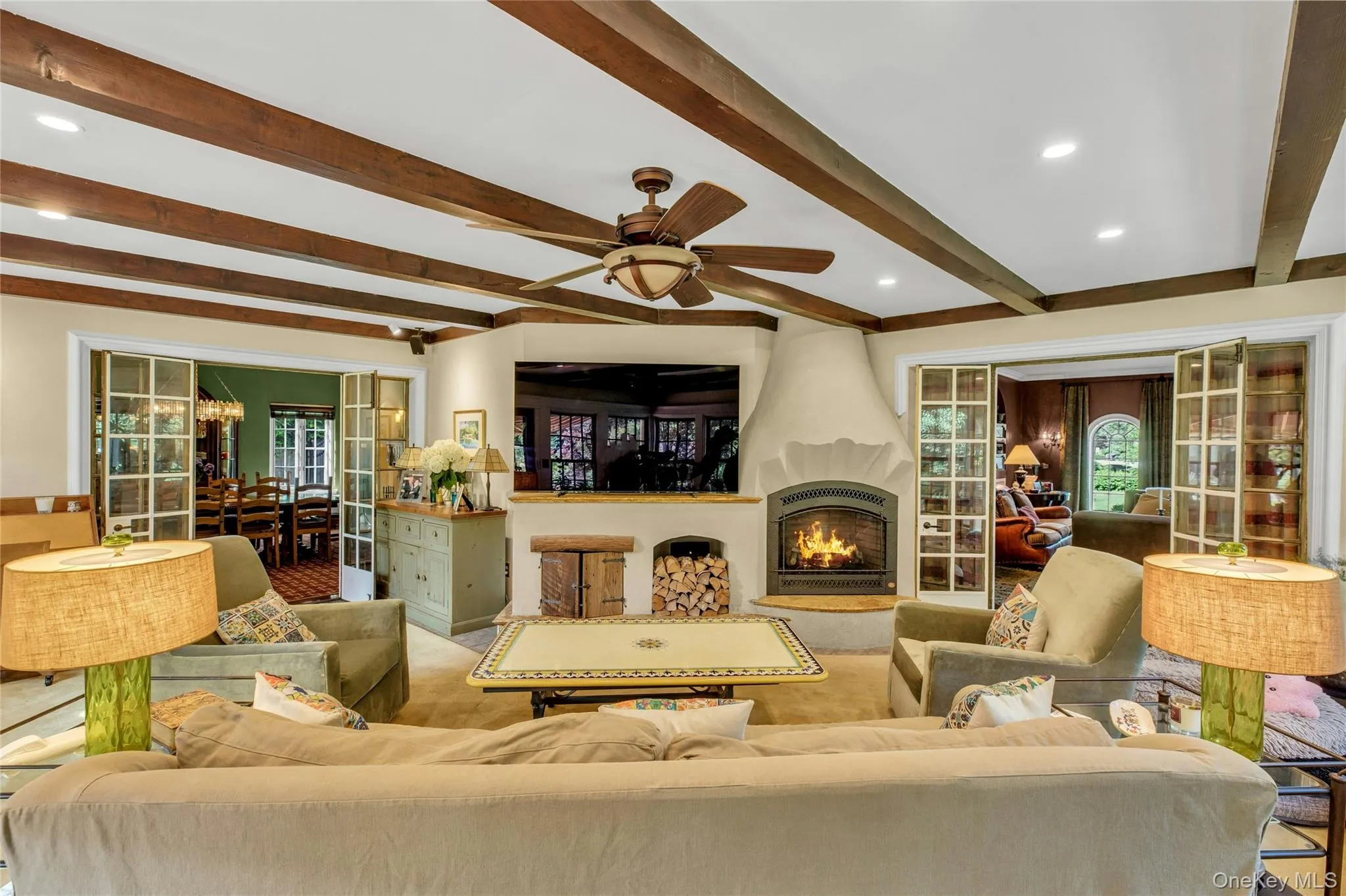 Southwest facing great room oozing with natural light, featuring beam ceiling, recessed lighting, french doors to den and back door leading to brick patio Southwest facing great room oozing with natural light, featuring beam ceiling, recessed lighting, french doors to den and back door leading to brick patio
