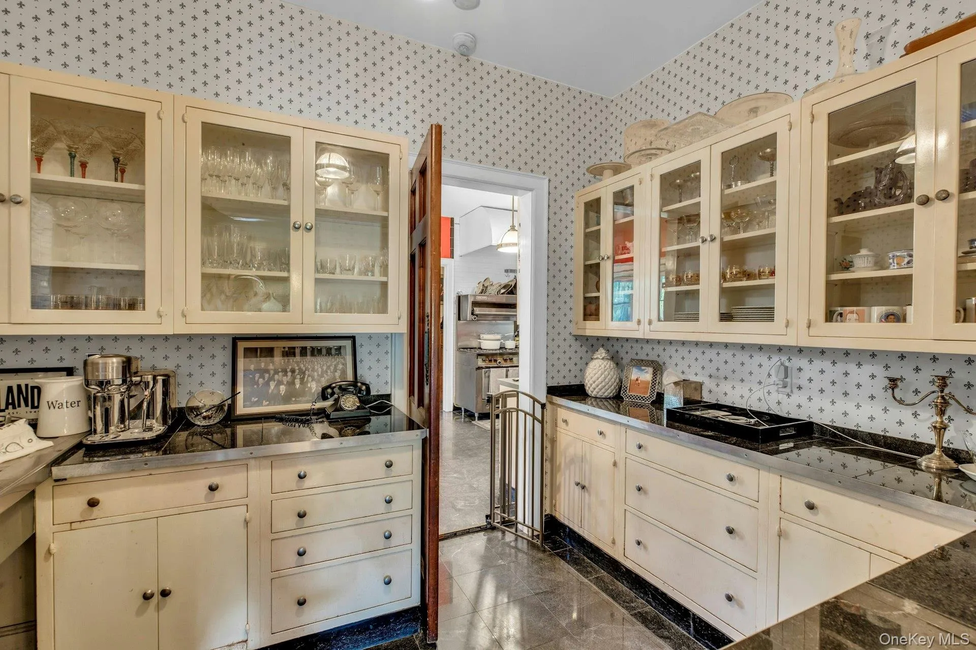 Butlers Pantry between formal dining room and kitchen, featuring cream cabinetry, stainless steel sink Butlers Pantry between formal dining room and kitchen, featuring cream cabinetry, stainless steel sink