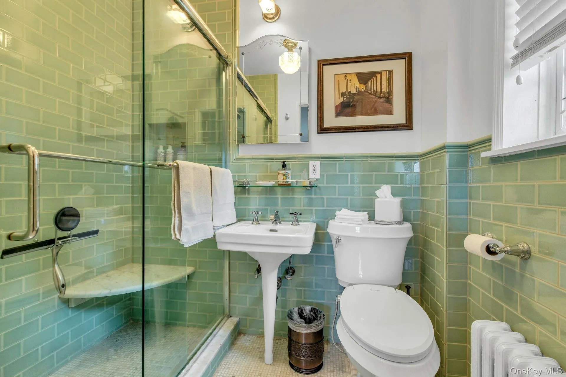 Newly renovated en-suite full bath featuring walk-in shower, subway walls, basketweave tile flooring, and wainscoting Newly renovated en-suite full bath featuring walk-in shower, subway walls, basketweave tile flooring, and wainscoting