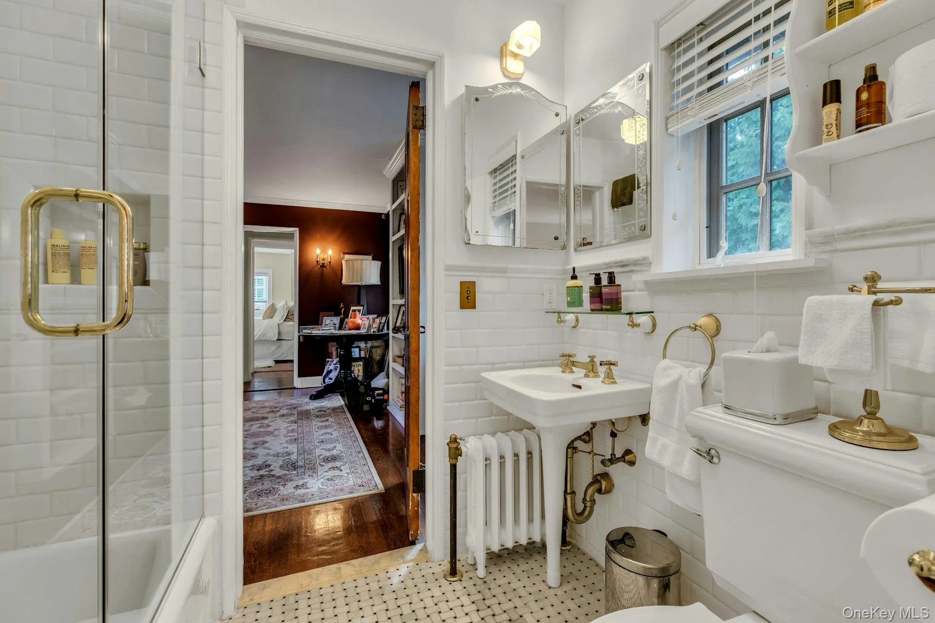 Newly renovated en-suite bathroom, shower / bath combination with glass door, and subway tile walls, basketweave tile floors Newly renovated en-suite bathroom, shower / bath combination with glass door, and subway tile walls, basketweave tile floors