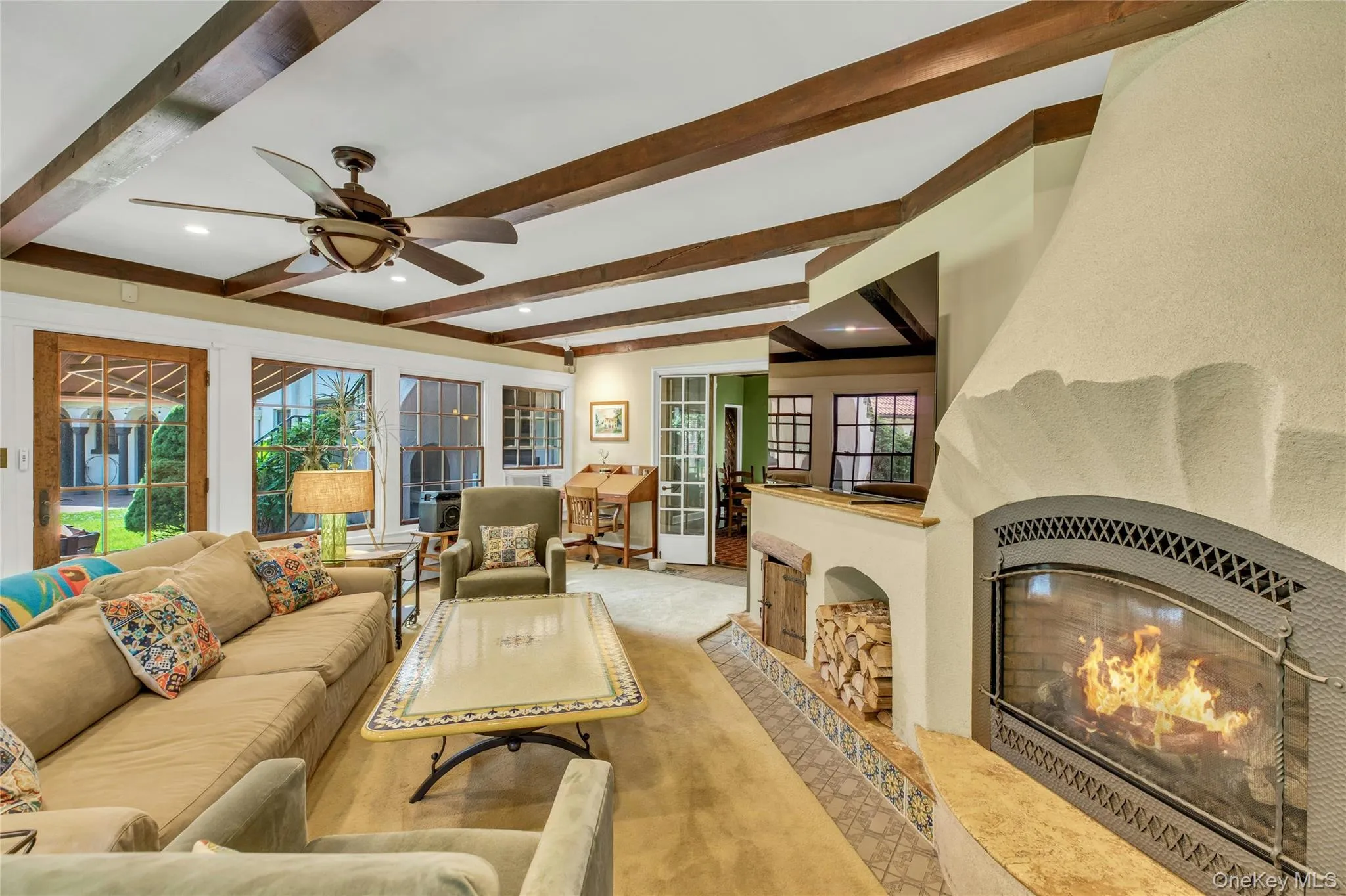 Southwest facing great room oozing with natural light, featuring beam ceiling, recessed lighting, french doors to den and back door leading to brick patio Southwest facing great room oozing with natural light, featuring beam ceiling, recessed lighting, french doors to den and back door leading to brick patio