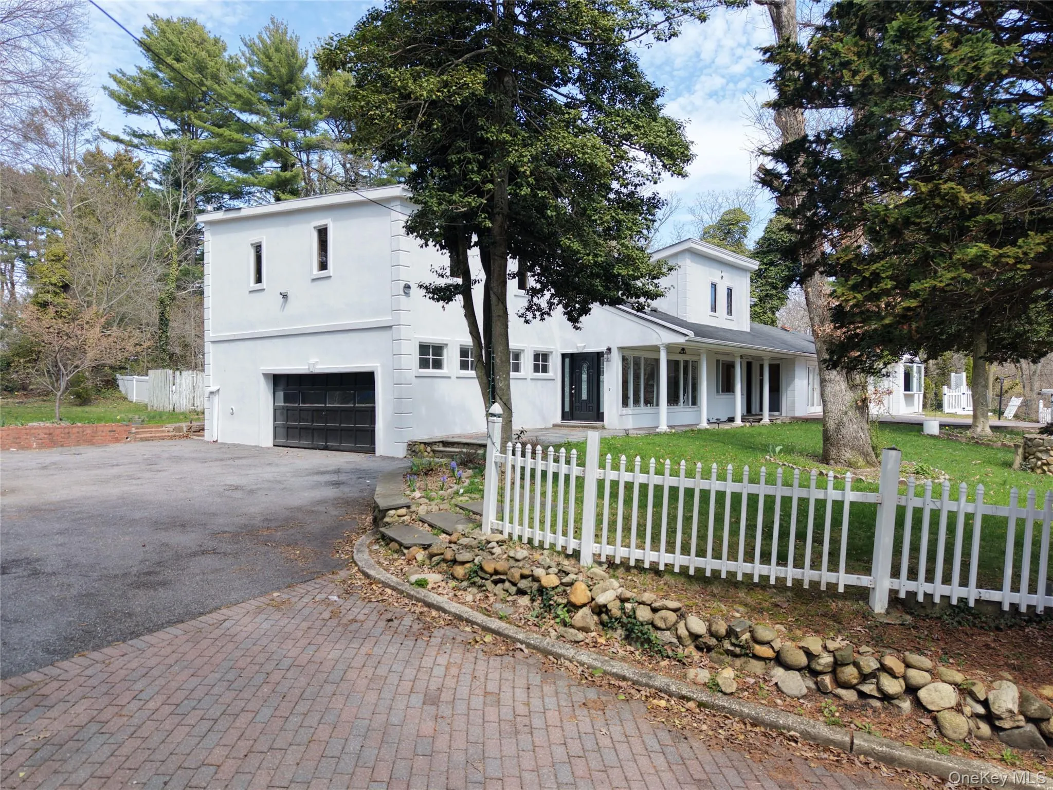 View of front of home with asphalt driveway, a garage, and covered porch View of front of home with asphalt driveway, a garage, and covered porch