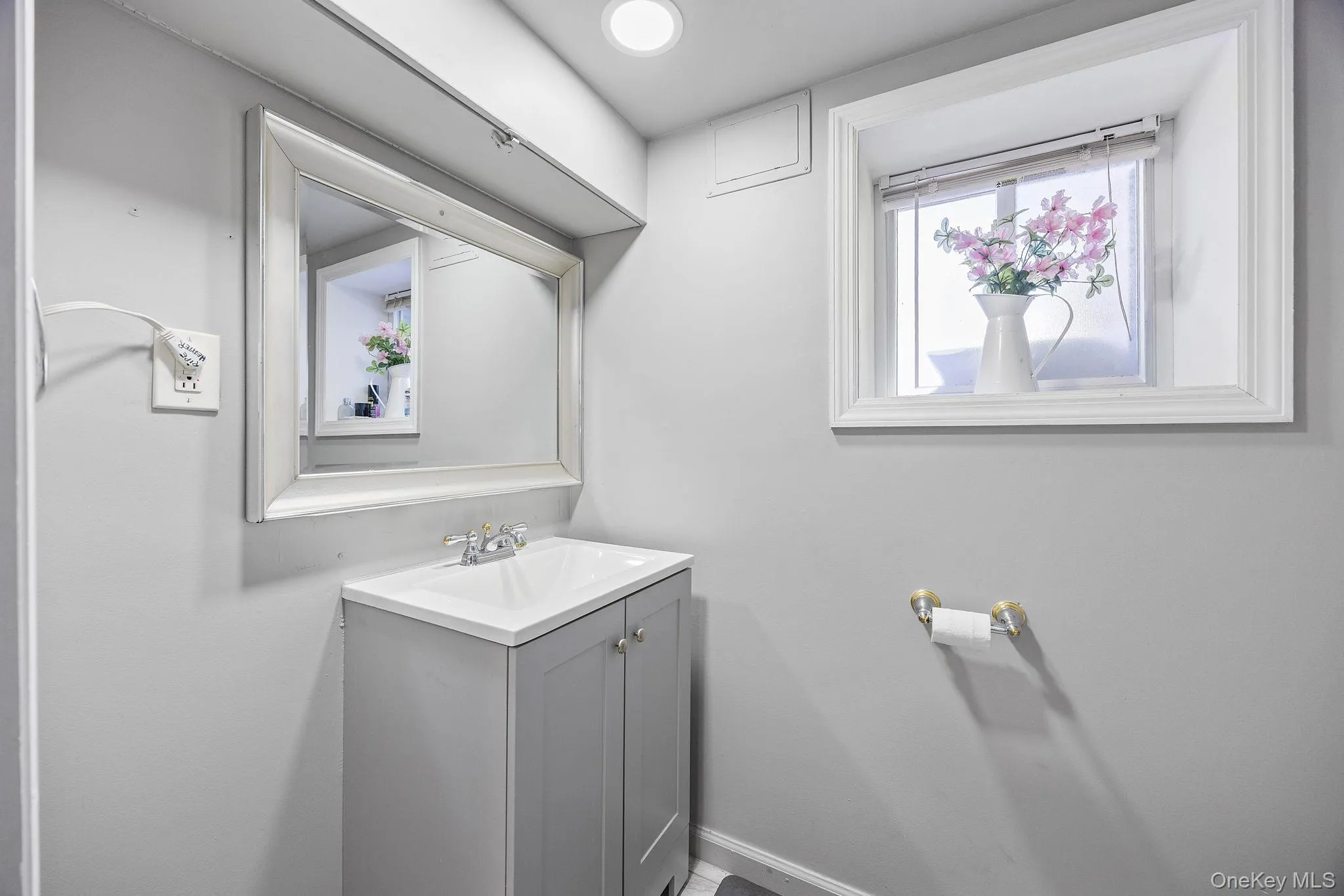 Half bathroom with vanity and baseboards Half bathroom with vanity and baseboards