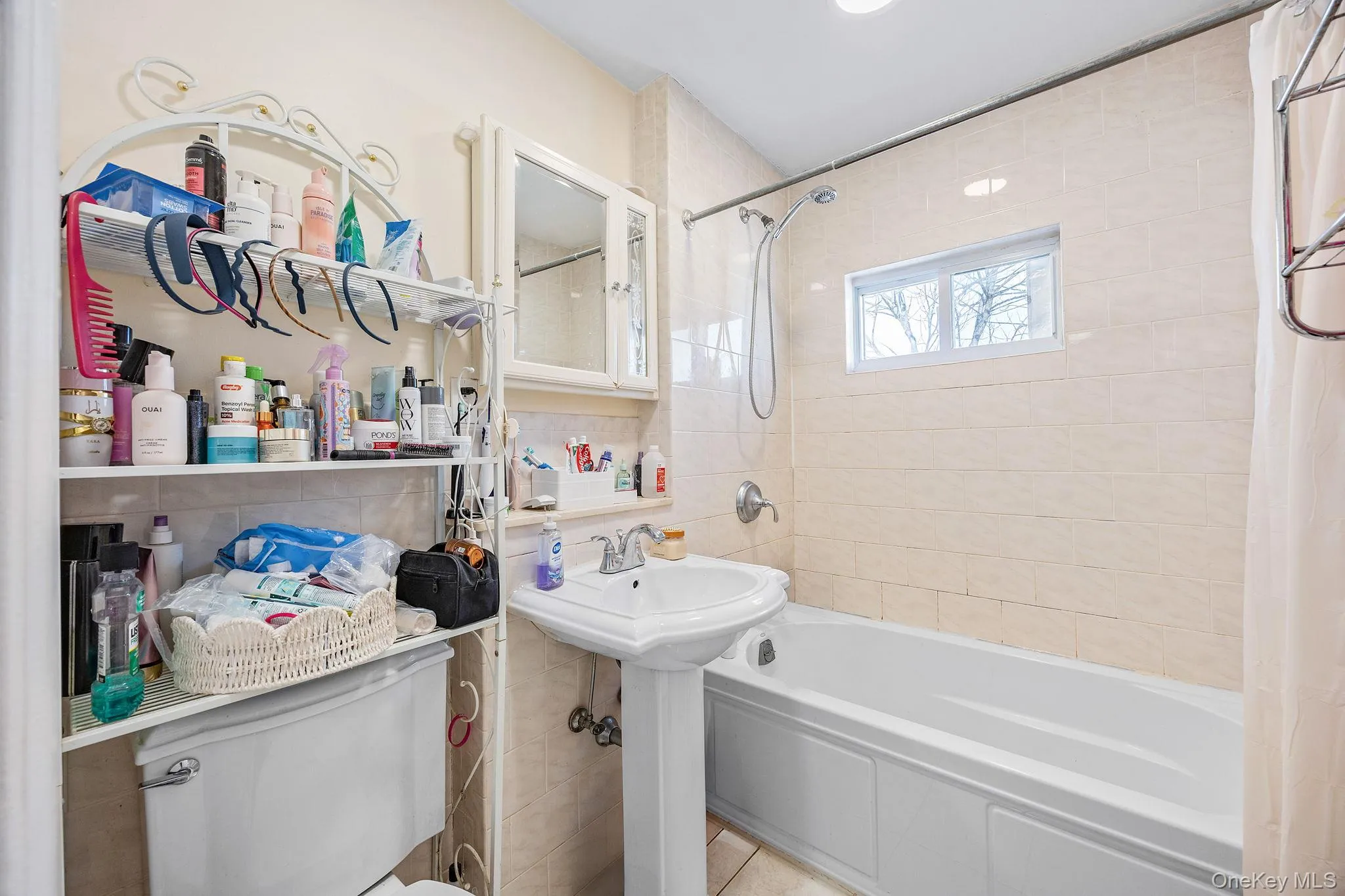 Full bath featuring shower / bath combo and tile walls Full bath featuring shower / bath combo and tile walls