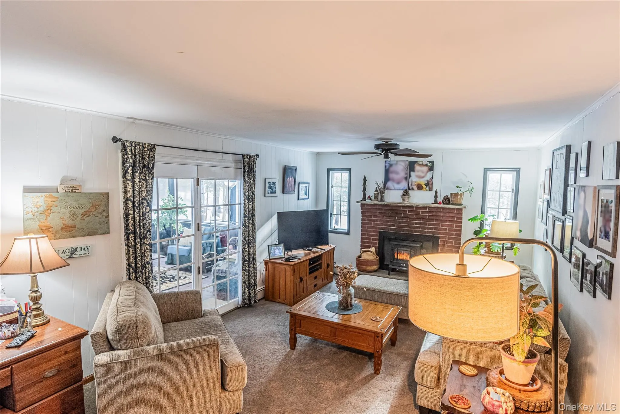 Living room featuring carpet floors, a ceiling fan, and crown molding Living room featuring carpet floors, a ceiling fan, and crown molding