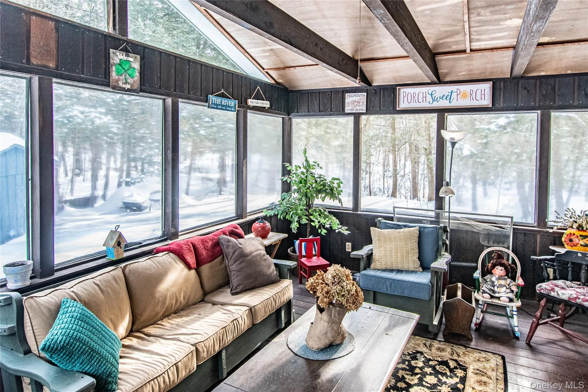 Sunroom / solarium featuring outdoor lounge area, hardwood / wood-style floors, a deck, and wooden walls Sunroom / solarium featuring outdoor lounge area, hardwood / wood-style floors, a deck, and wooden walls