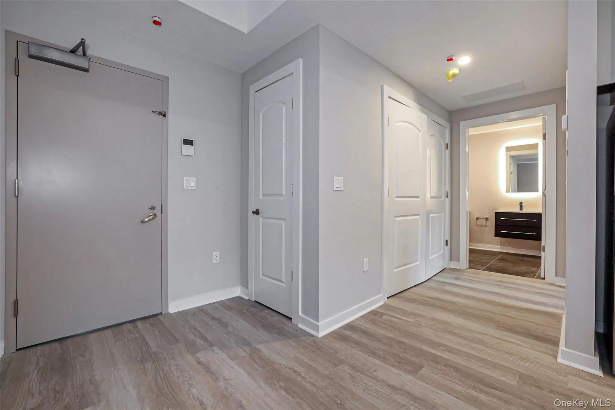 Hallway with light wood finished floors and baseboards Hallway with light wood finished floors and baseboards