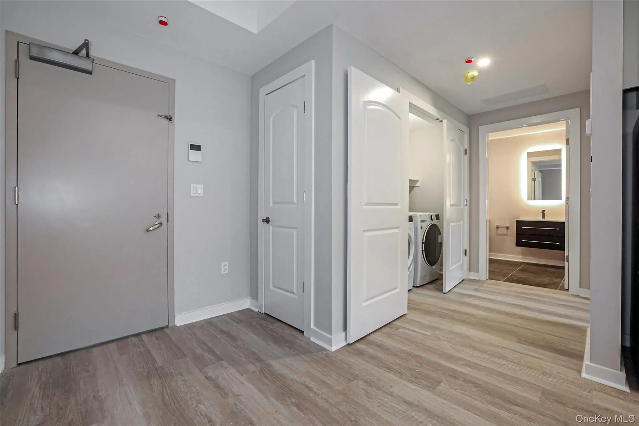 Washroom with light wood-style floors and baseboards Washroom with light wood-style floors and baseboards