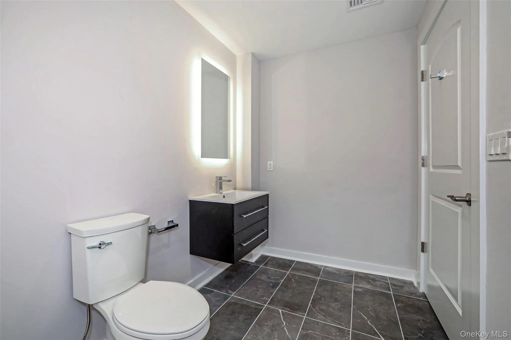 Half bathroom with vanity and toilet Half bathroom with vanity and toilet