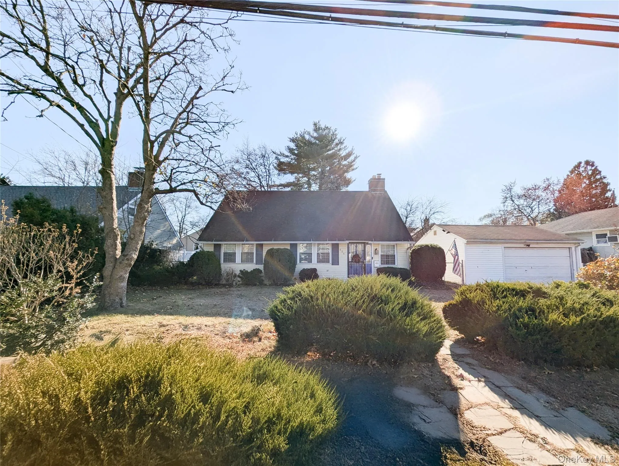 View of front of house featuring a garage, an outdoor structure, and a front lawn View of front of house featuring a garage, an outdoor structure, and a front lawn