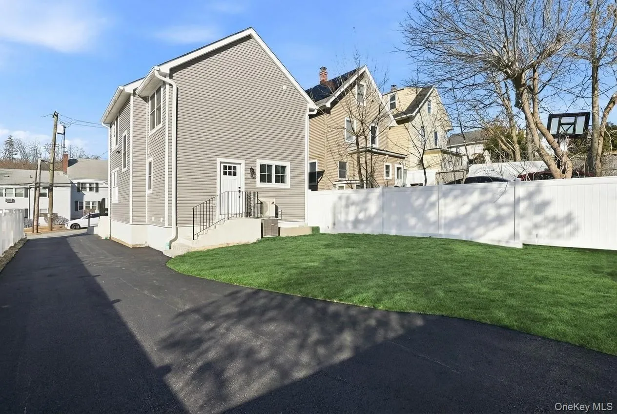 Driveway virtually paved to illustrate potential, offering a spacious area for convenient parking. Driveway virtually paved to illustrate potential, offering a spacious area for convenient parking.