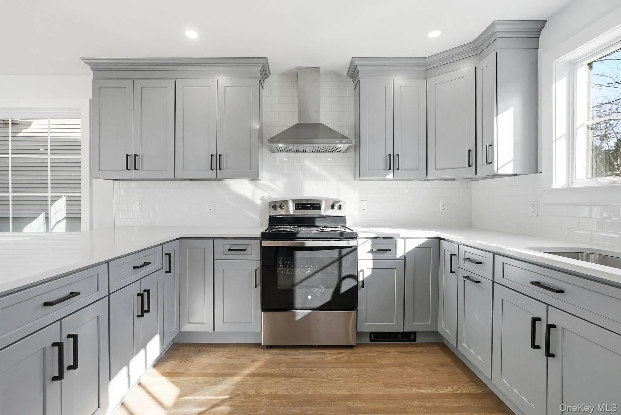 Brand new kitchen with stylish gray shaker cabinetry, complemented by sleek quartz countertops for a modern, elegant look. Brand new kitchen with stylish gray shaker cabinetry, complemented by sleek quartz countertops for a modern, elegant look.