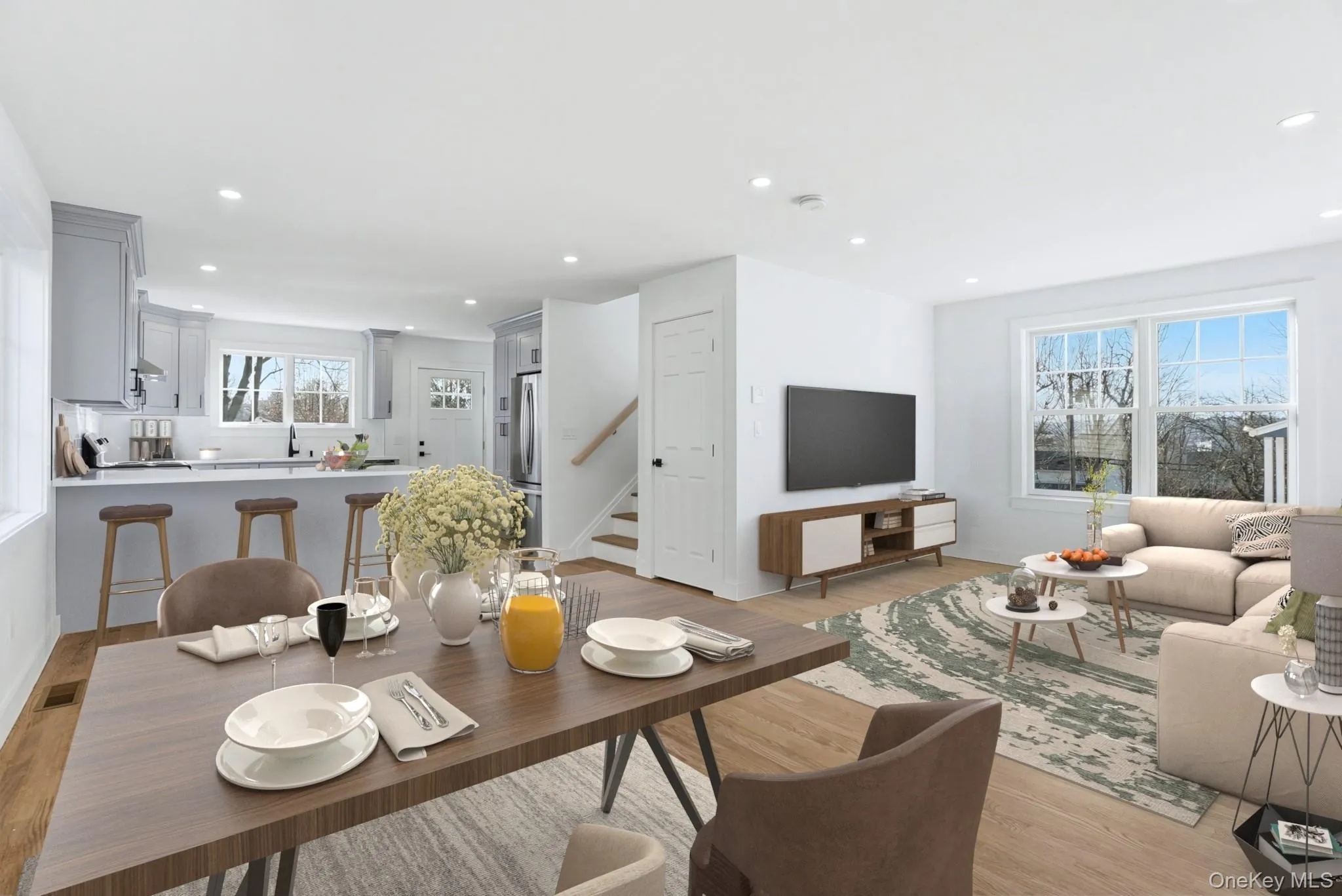 Virtually staged kitchen featuring island seating for breakfast and a comfortable dining area. Virtually staged kitchen featuring island seating for breakfast and a comfortable dining area.