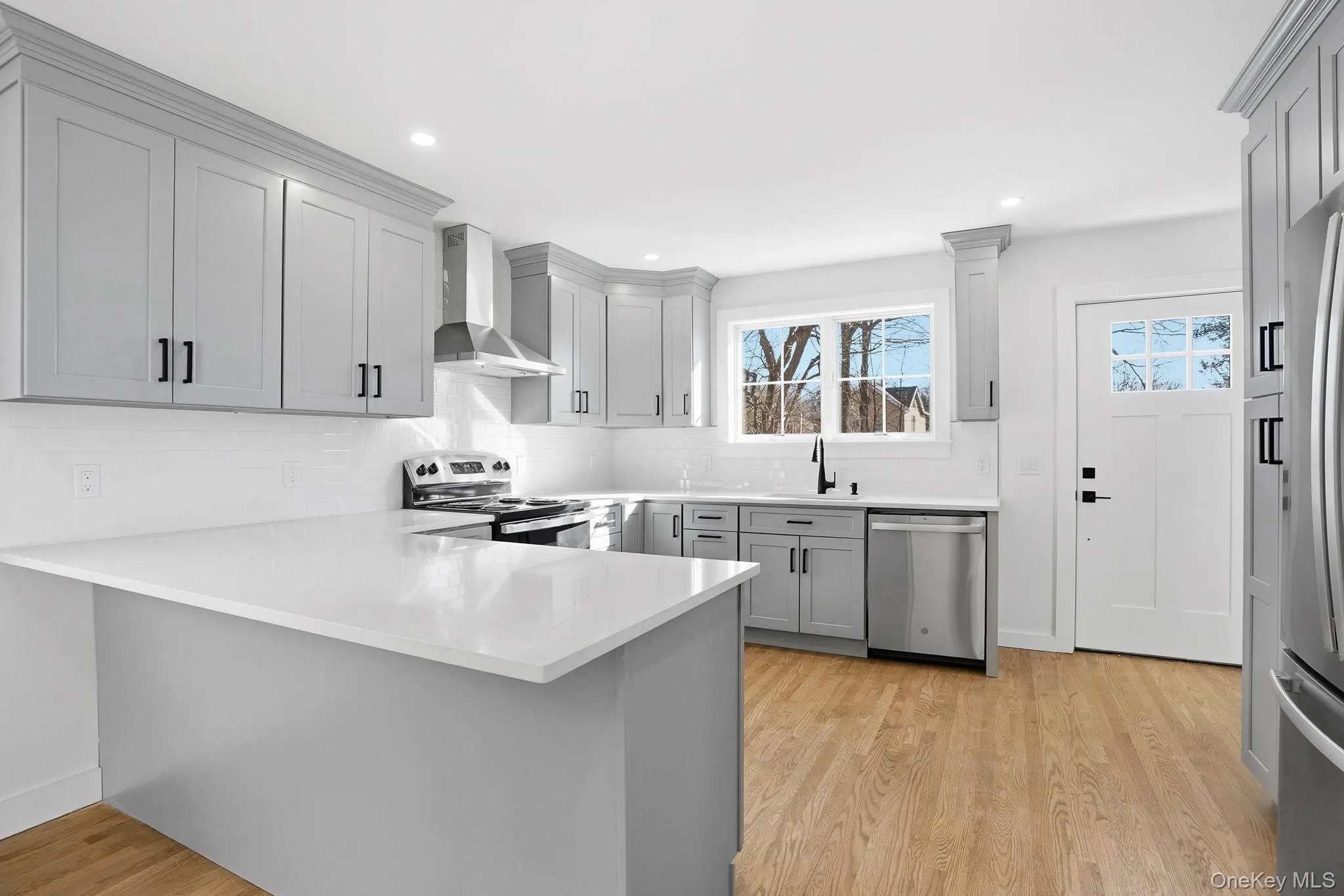 Enjoy a fully updated kitchen with gray shaker cabinets and elegant quartz counters, perfect for cooking and entertaining. Enjoy a fully updated kitchen with gray shaker cabinets and elegant quartz counters, perfect for cooking and entertaining.