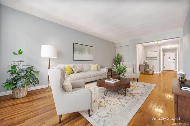 A spacious living room featuring beautiful hardwood floors.