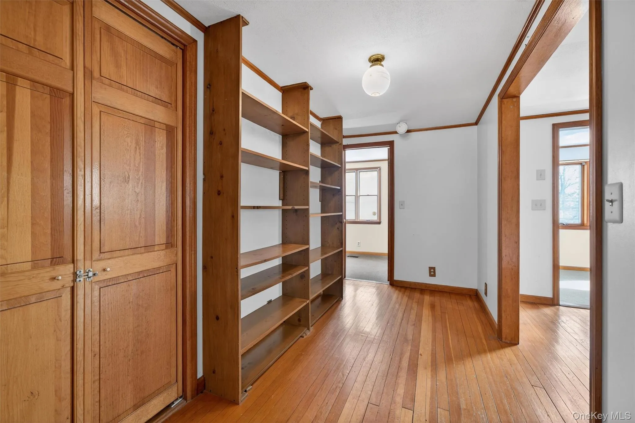 Hallway with bookshelves and closet Hallway with bookshelves and closet