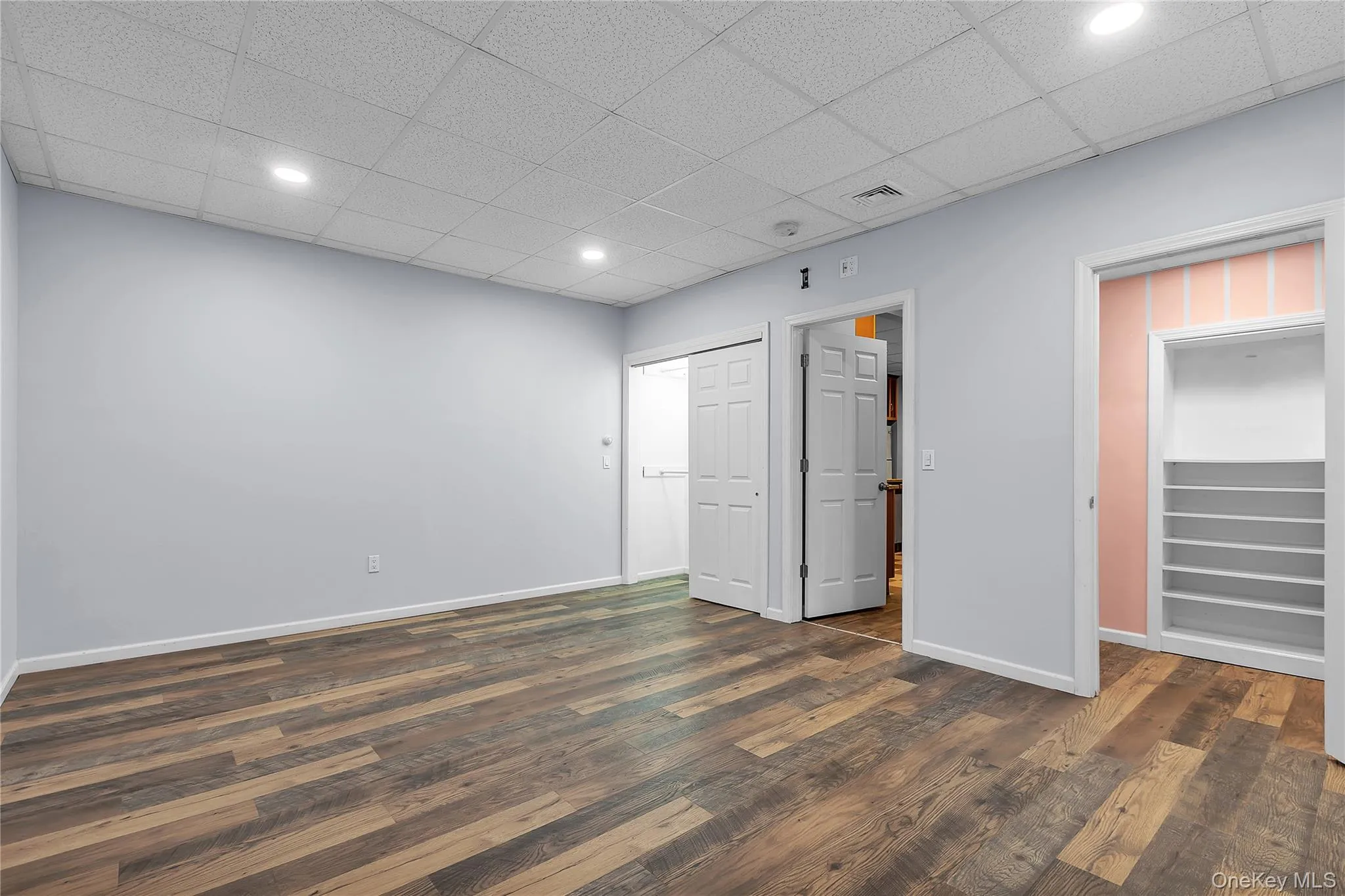 Bedroom features a walk-in closet along with a second closet. Bedroom features a walk-in closet along with a second closet.