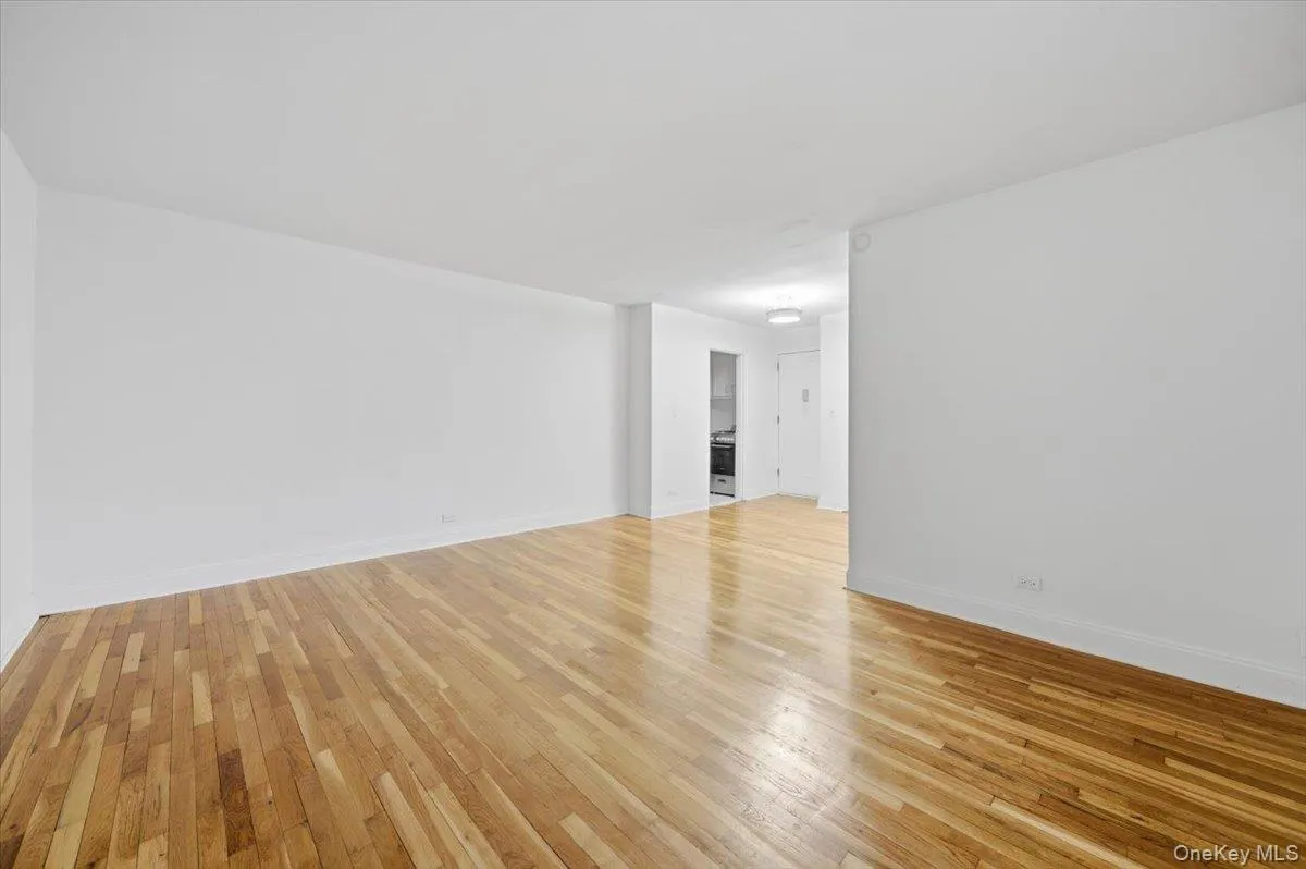 Living/Bedroom area with light wood-type flooring and baseboards Living/Bedroom area with light wood-type flooring and baseboards