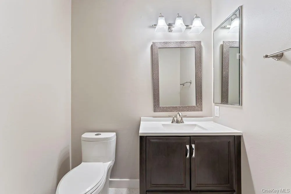 Half bath with vanity and toilet Half bath with vanity and toilet