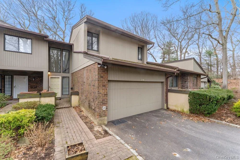 View of front of house featuring brick siding, driveway, and a garage View of front of house featuring brick siding, driveway, and a garage