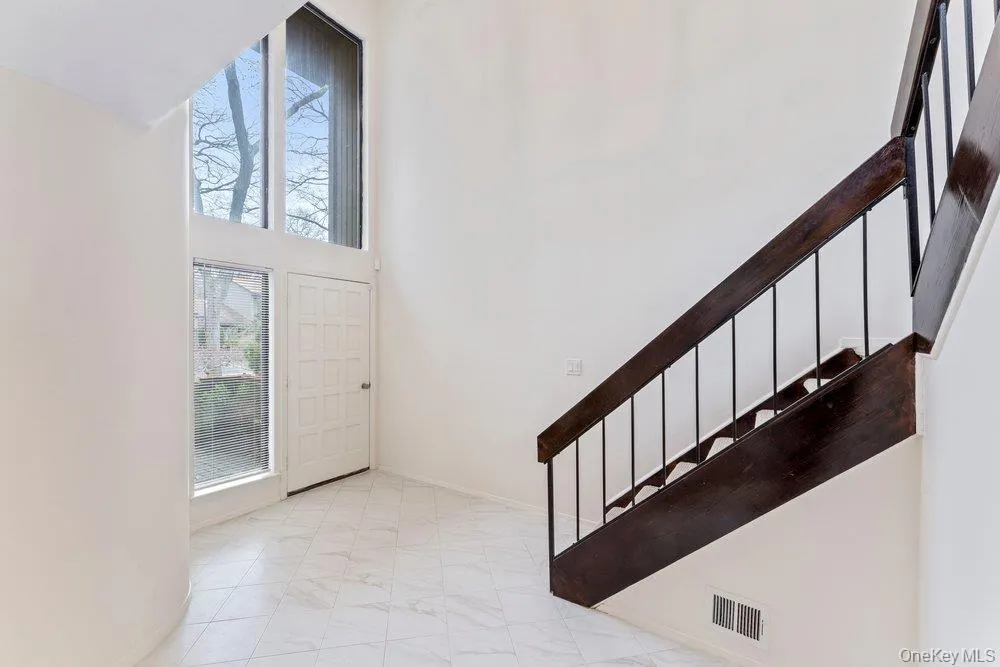 Foyer entrance with stairs and a high ceiling Foyer entrance with stairs and a high ceiling