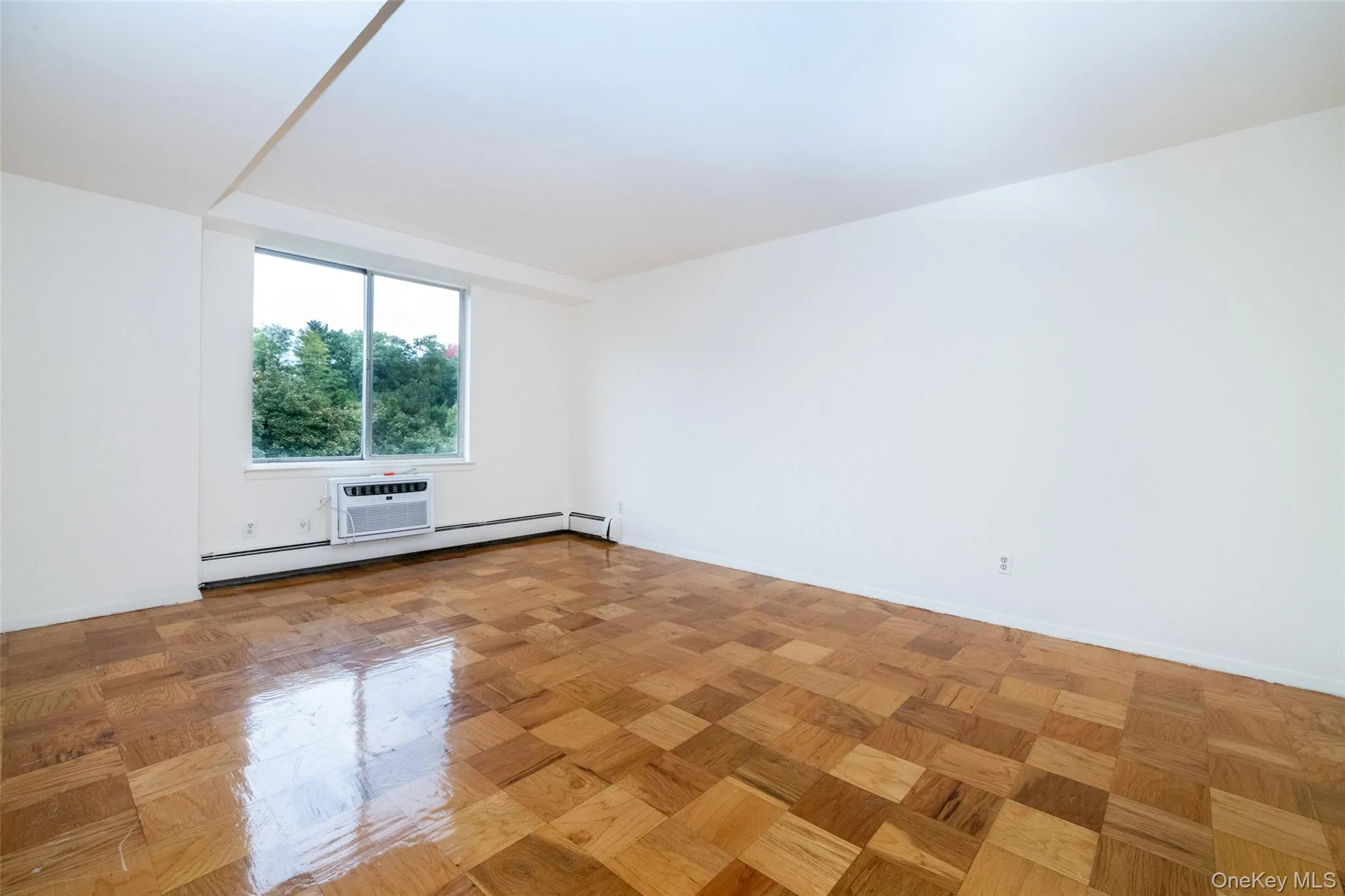 Empty room with baseboards and a baseboard radiator Empty room with baseboards and a baseboard radiator