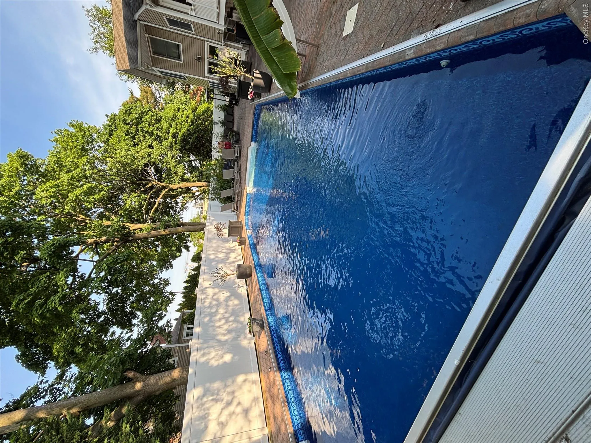 Backyard swimming pool with a patterned liner and integrated pool cover newly installed 5/2026 Backyard swimming pool with a patterned liner and integrated pool cover newly installed 5/2026