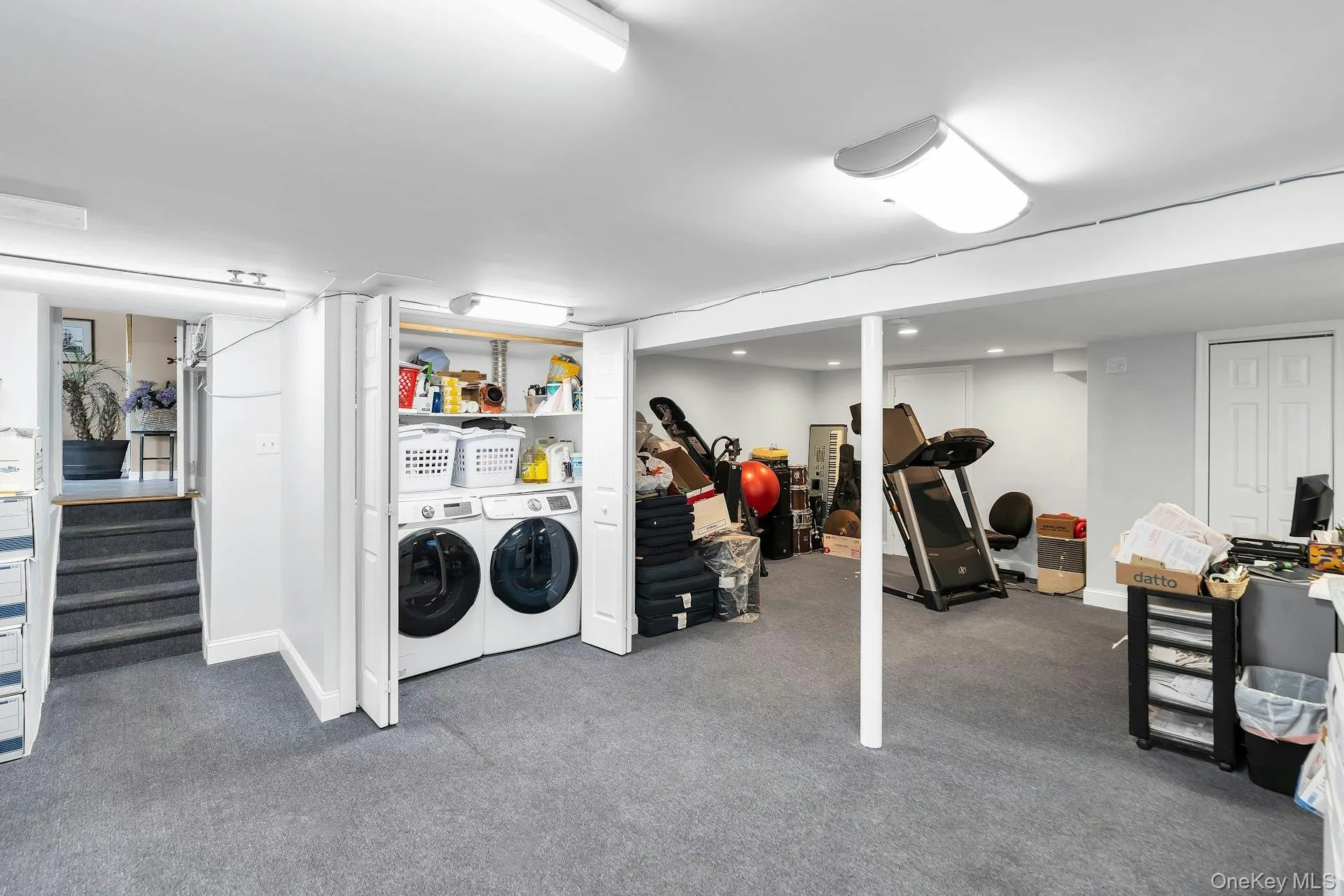 Finished basement area featuring carpet and washing machine and dryer Finished basement area featuring carpet and washing machine and dryer