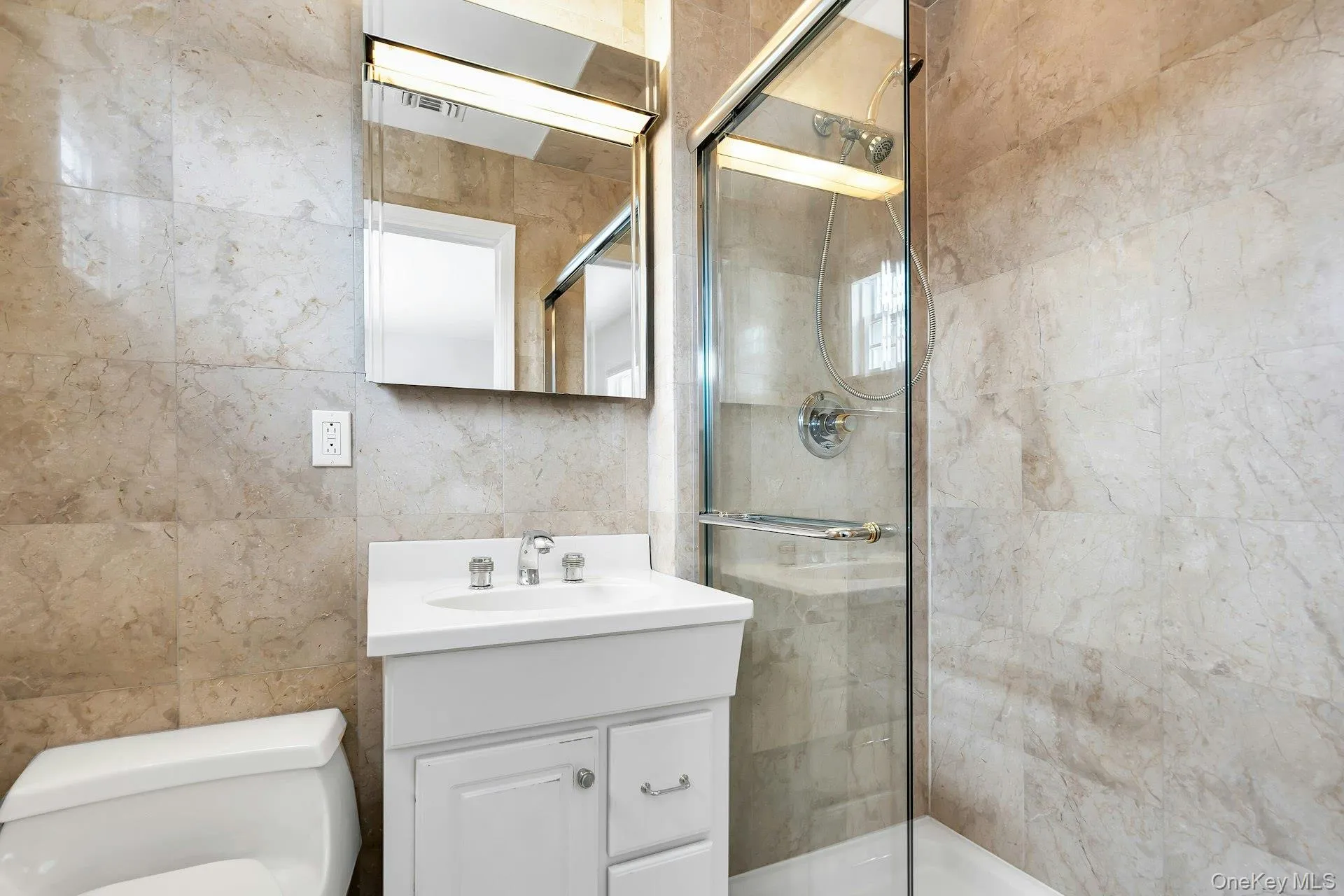 Master Full bath featuring tile walls, vanity, and tiled shower Master Full bath featuring tile walls, vanity, and tiled shower