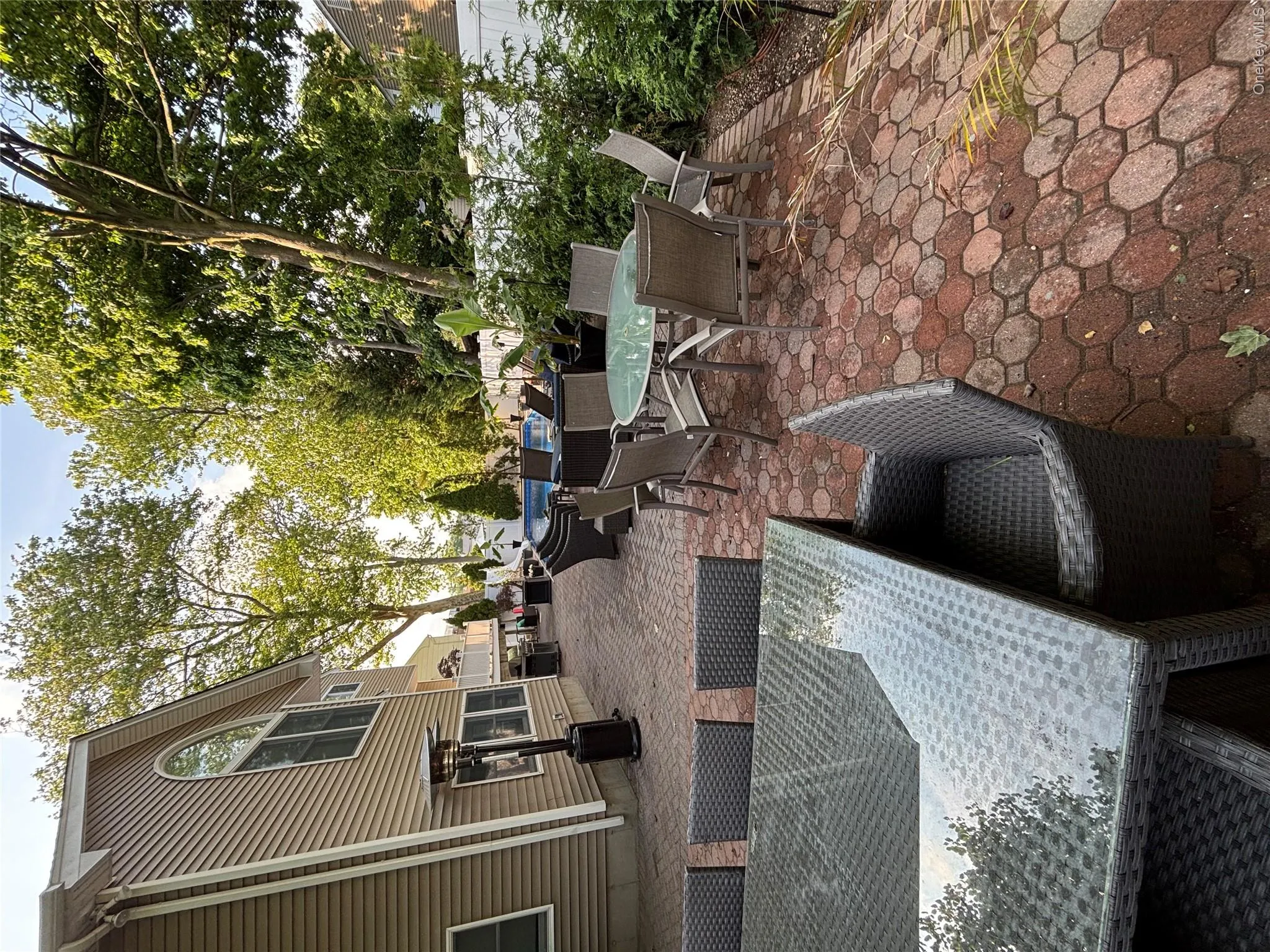 Expansive outdoor brick paver patio featuring a built-in swimming pool and new fence and landscaping 5/2026 Expansive outdoor brick paver patio featuring a built-in swimming pool and new fence and landscaping 5/2026