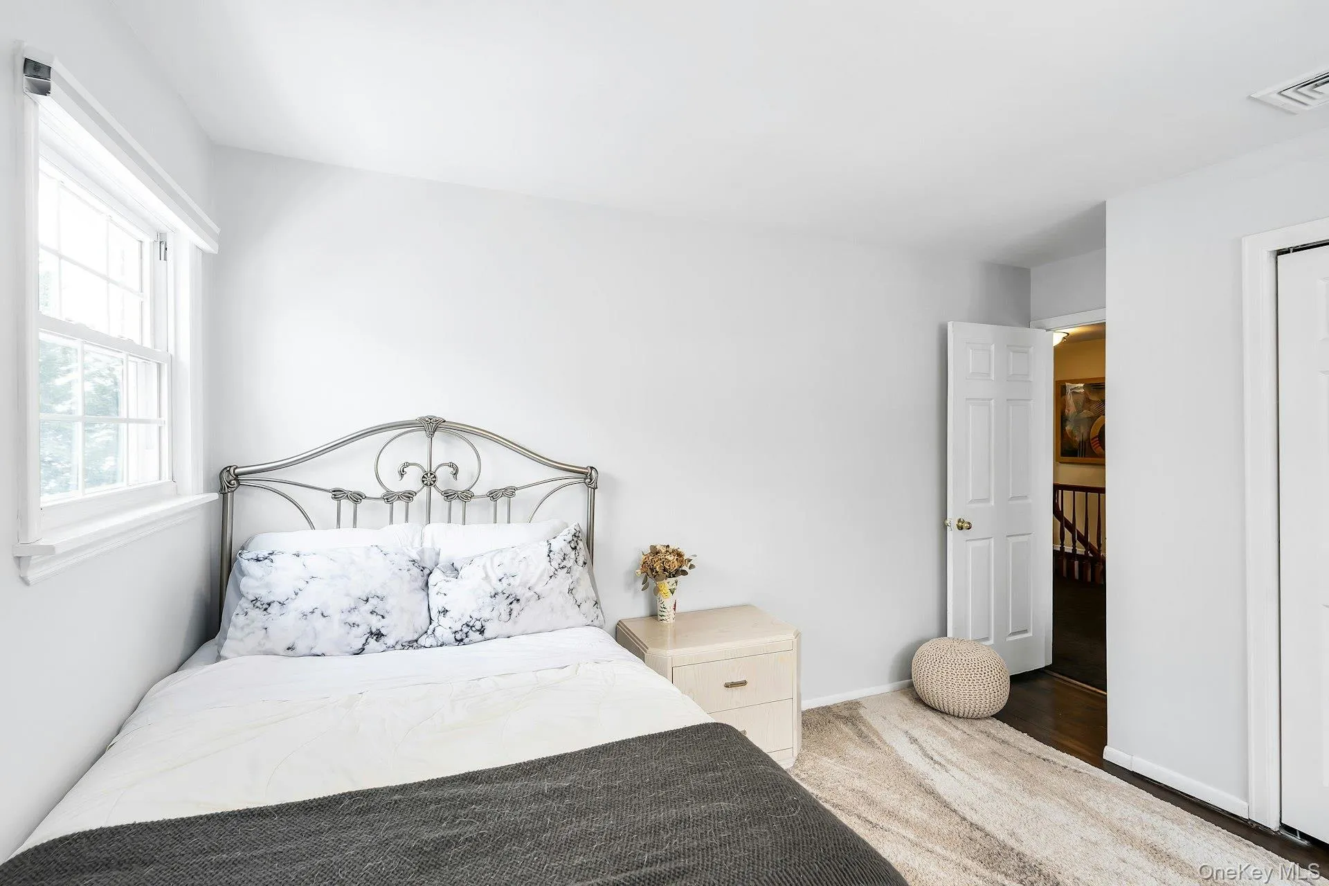 Bedroom with wood-style flooring and baseboards Bedroom with wood-style flooring and baseboards