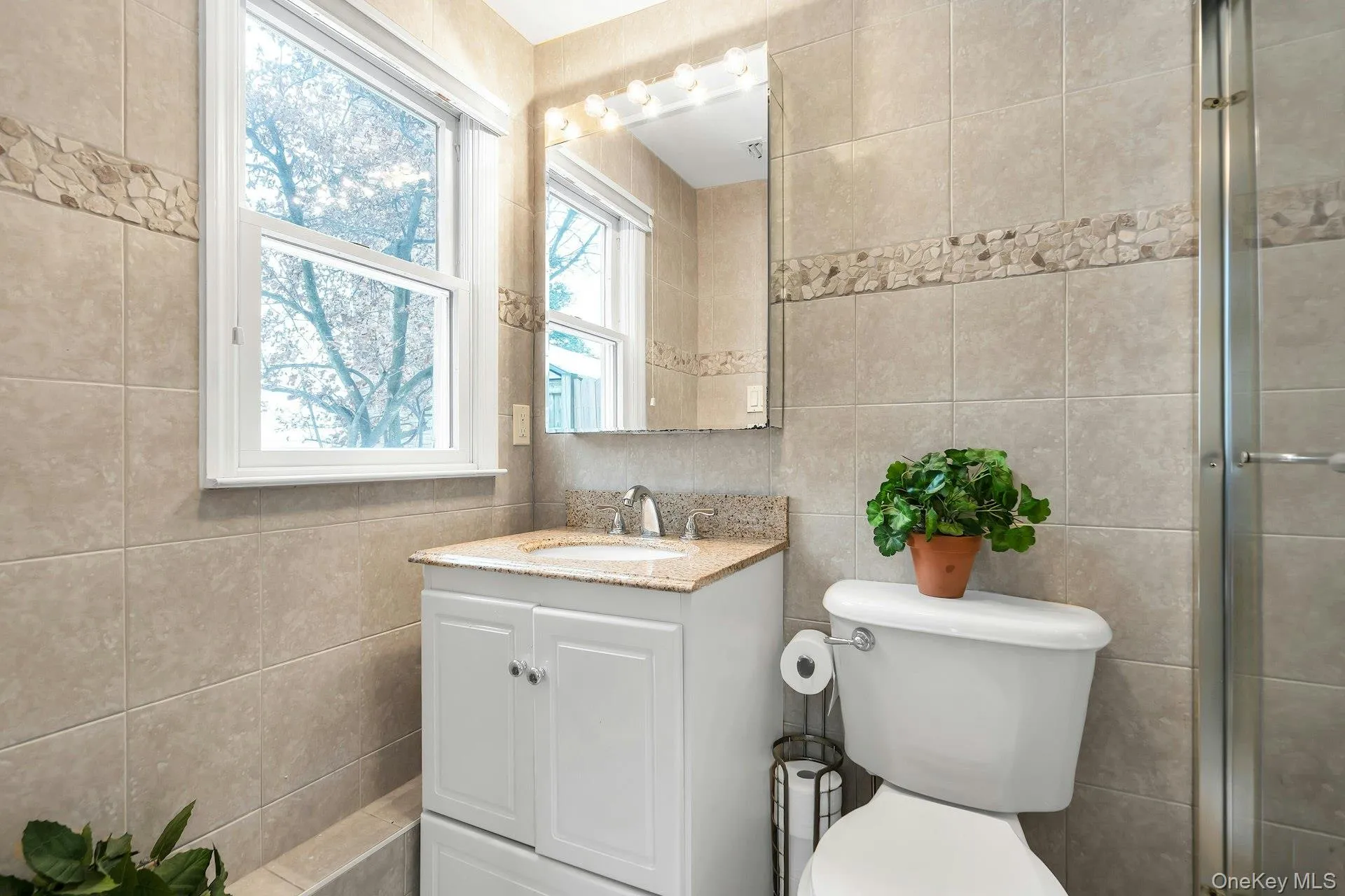 Master Bathroom with vanity, tile walls, and a shower with shower door Master Bathroom with vanity, tile walls, and a shower with shower door