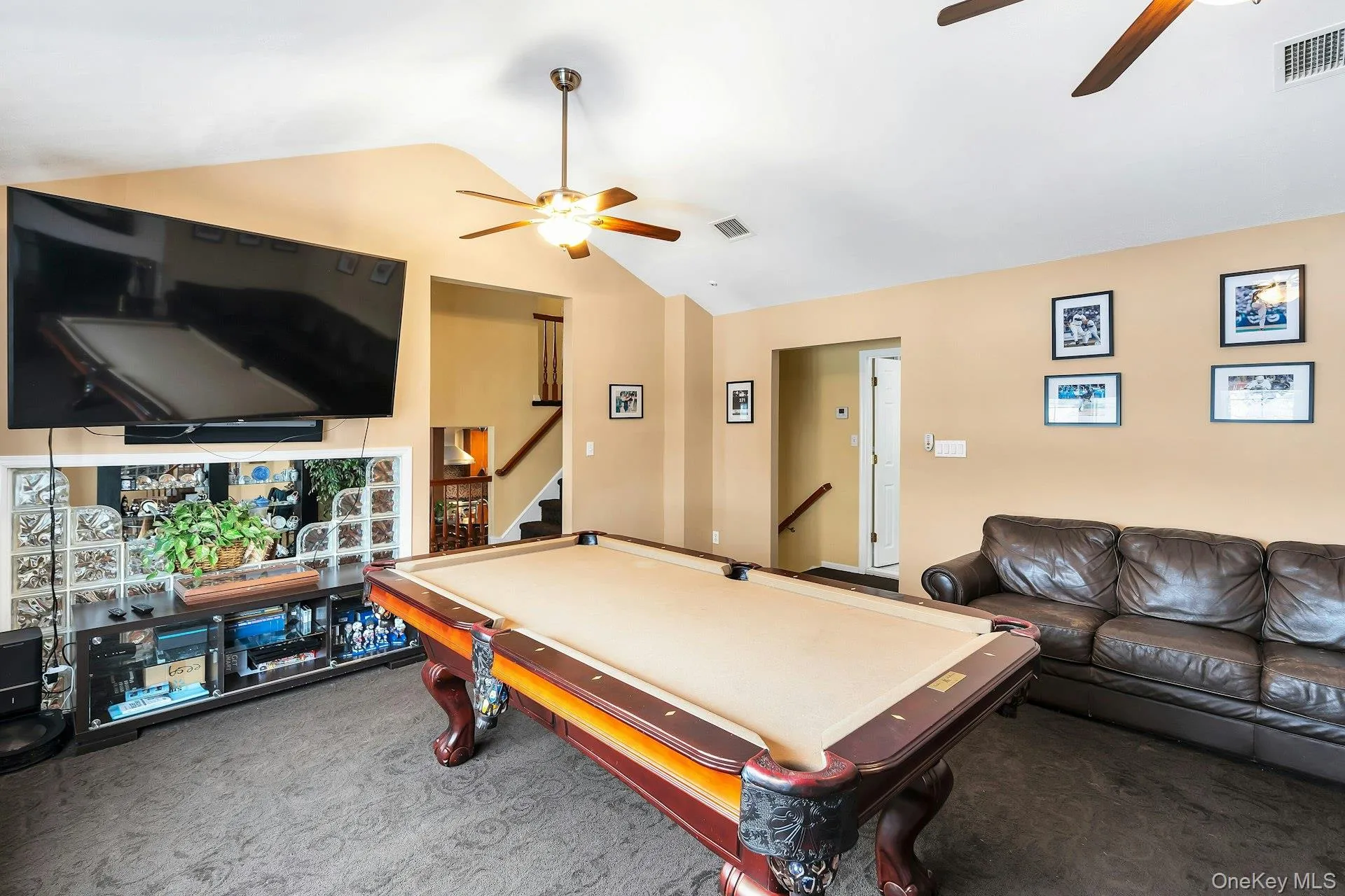 Living room with ceiling fan, carpet floors, and pool table Living room with ceiling fan, carpet floors, and pool table