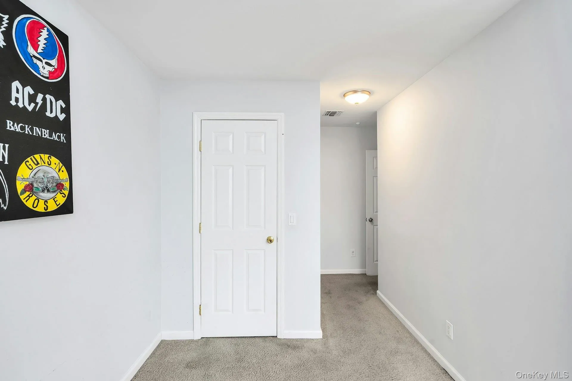 Bedroom featuring light carpet and baseboards Bedroom featuring light carpet and baseboards