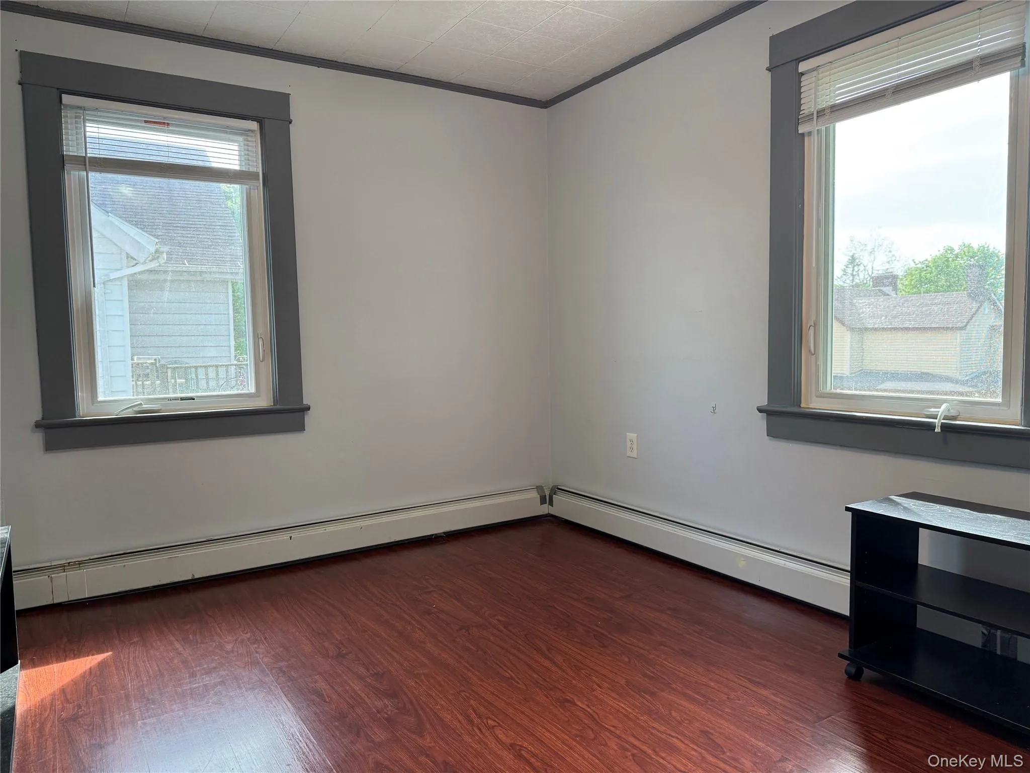 Empty room with wood finished floors and ornamental molding Empty room with wood finished floors and ornamental molding