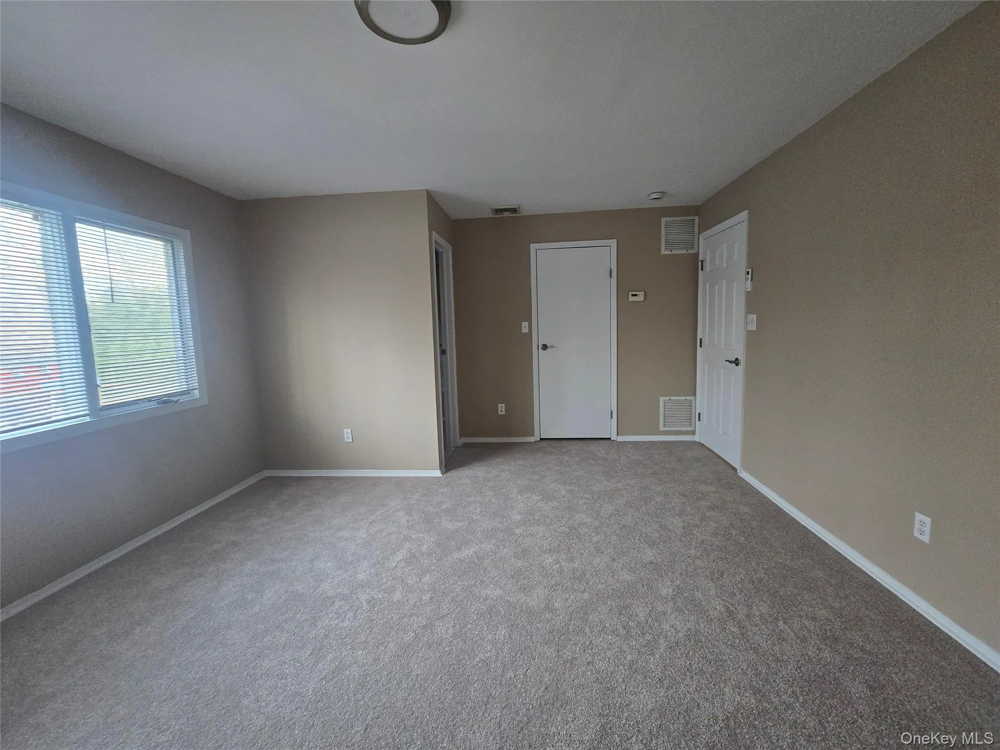 Empty room featuring carpet and baseboards Empty room featuring carpet and baseboards