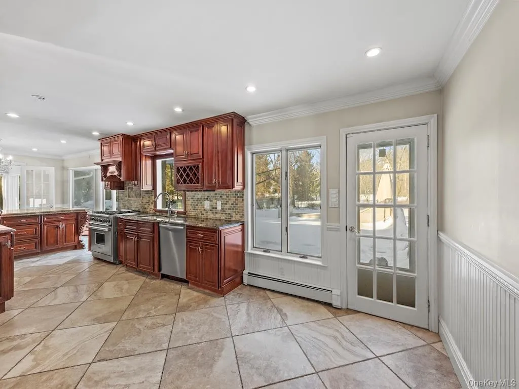 A spacious kitchen with a breakfast area that overlooks a private backyard. A spacious kitchen with a breakfast area that overlooks a private backyard.