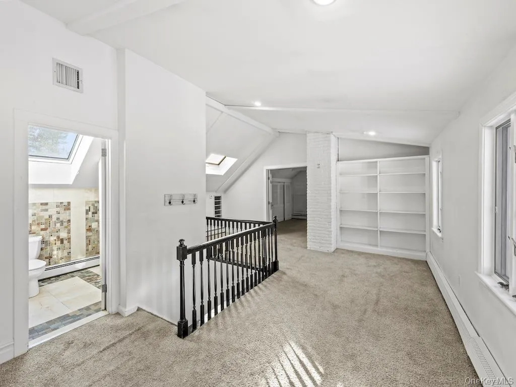 2nd floor carpeted hallway with skylight 2nd floor carpeted hallway with skylight