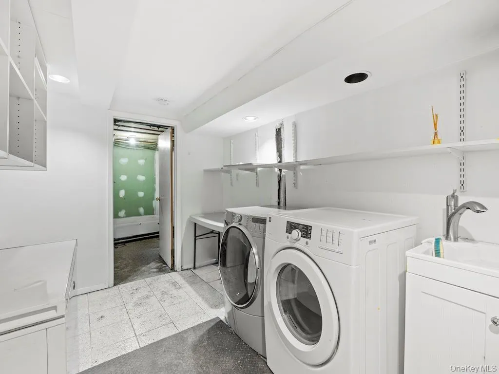 Laundry area featuring washer and dryer and light floors Laundry area featuring washer and dryer and light floors