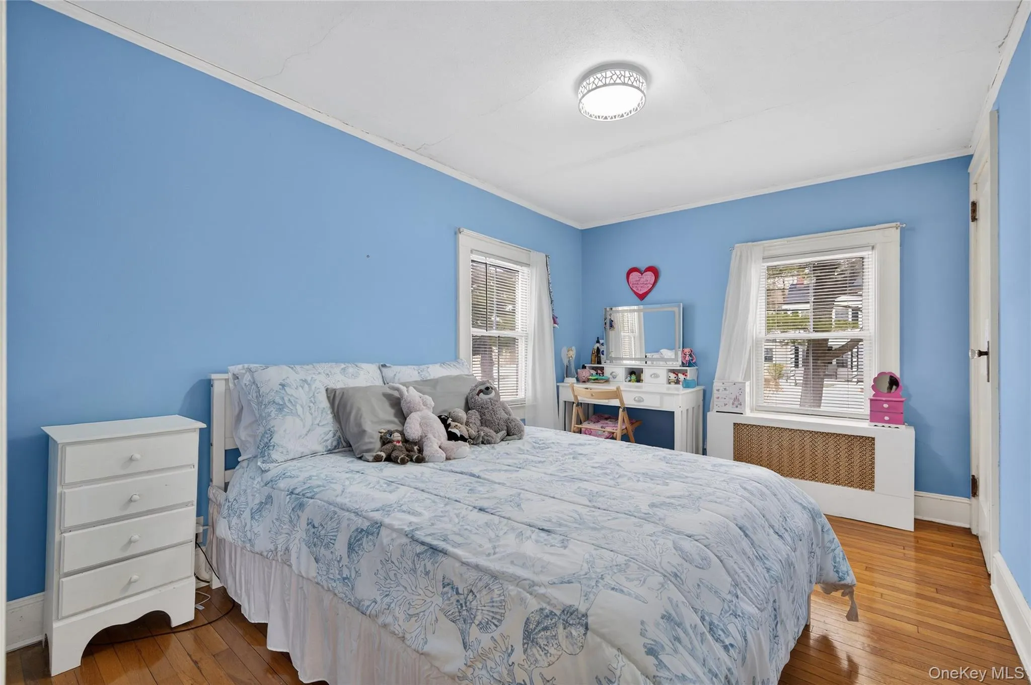 Second bedroom with hardwood floors and windows to the front. Second bedroom with hardwood floors and windows to the front.