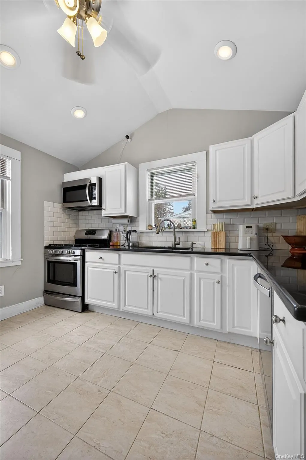 Bright sunny Kitchen with ceiling fan, recessed lighting and plenty of space in the cabinetry. Bright sunny Kitchen with ceiling fan, recessed lighting and plenty of space in the cabinetry.