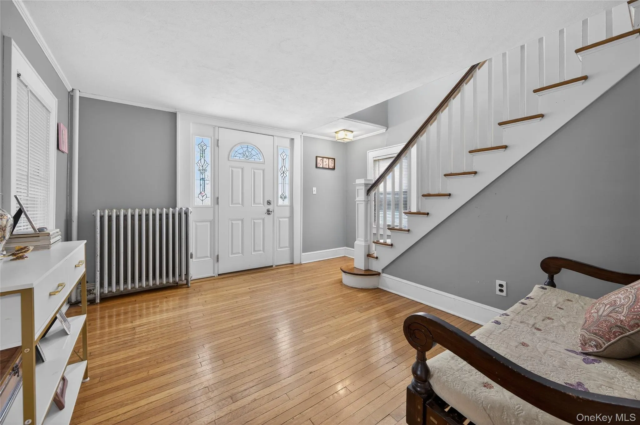 Entry to charming Colonial with deorative front door side window panels hardwood floors and stairs to the second floor. Entry to charming Colonial with deorative front door side window panels hardwood floors and stairs to the second floor.